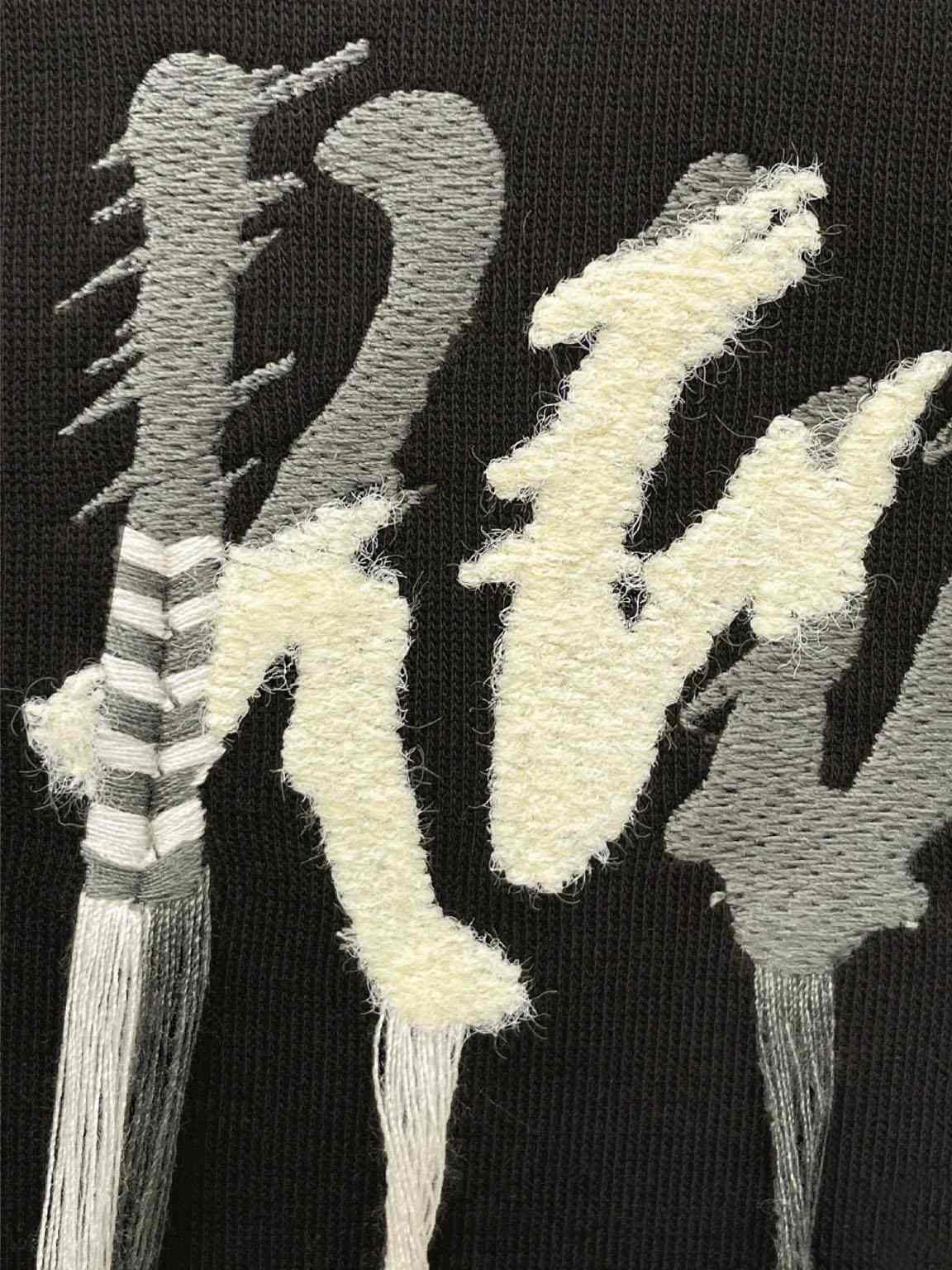 Multiple tassel embroidery decorations on apparel