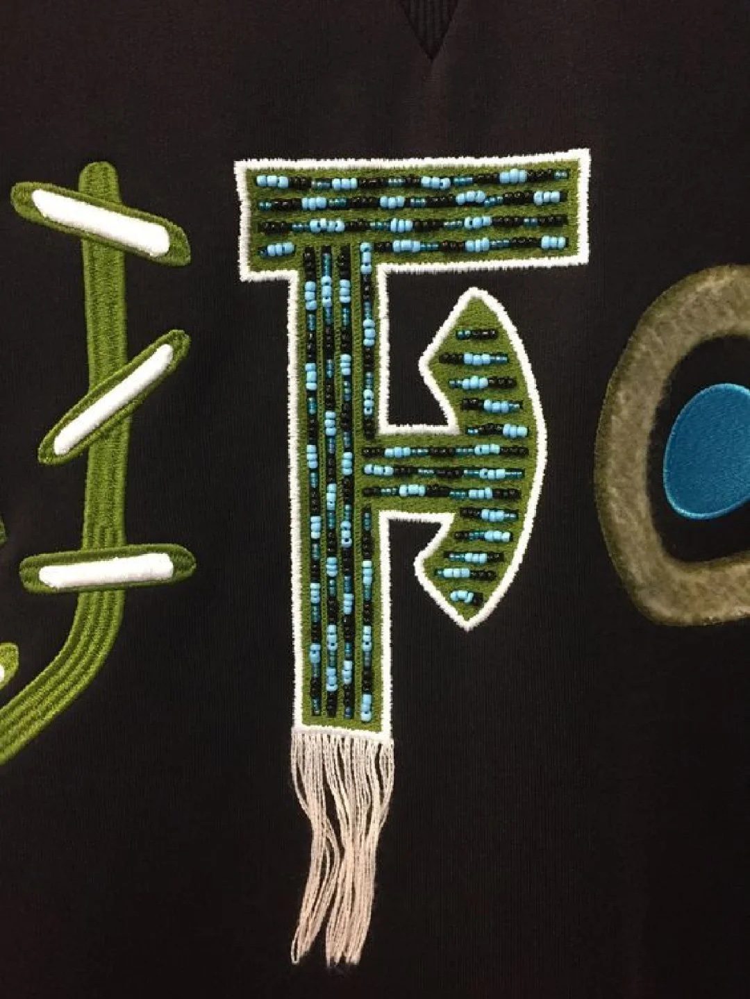 Tassel embroidery stitch detail on clothing