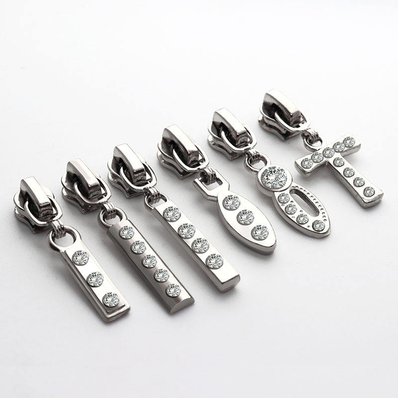 Branded metal zipper pulls for garment manufacturing